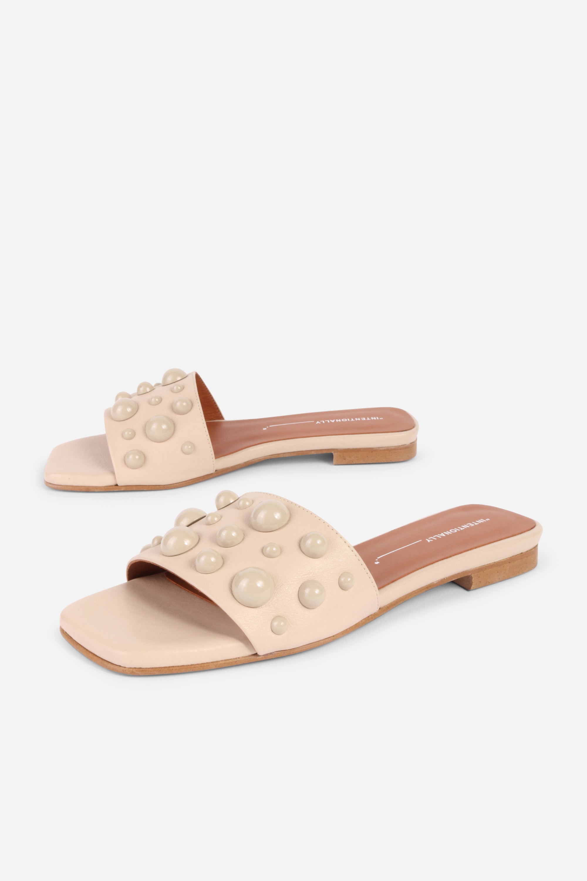 INTENTIONALLY __________. Cocktail Leather Slide