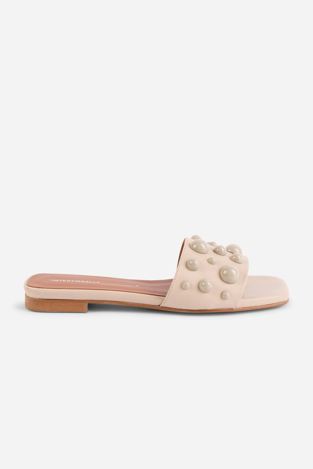 INTENTIONALLY __________. Cocktail Leather Slide