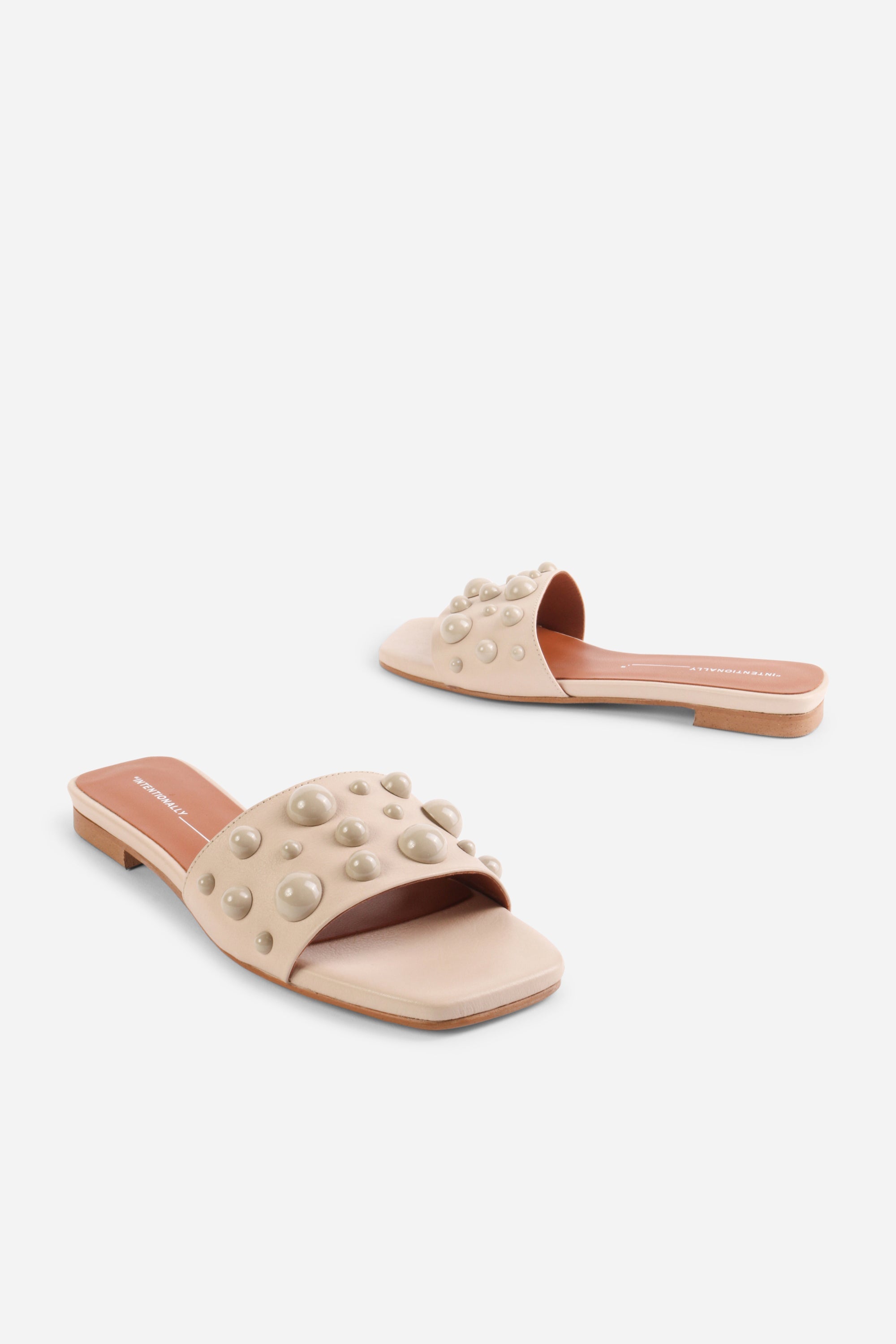 INTENTIONALLY __________. Cocktail Leather Slide