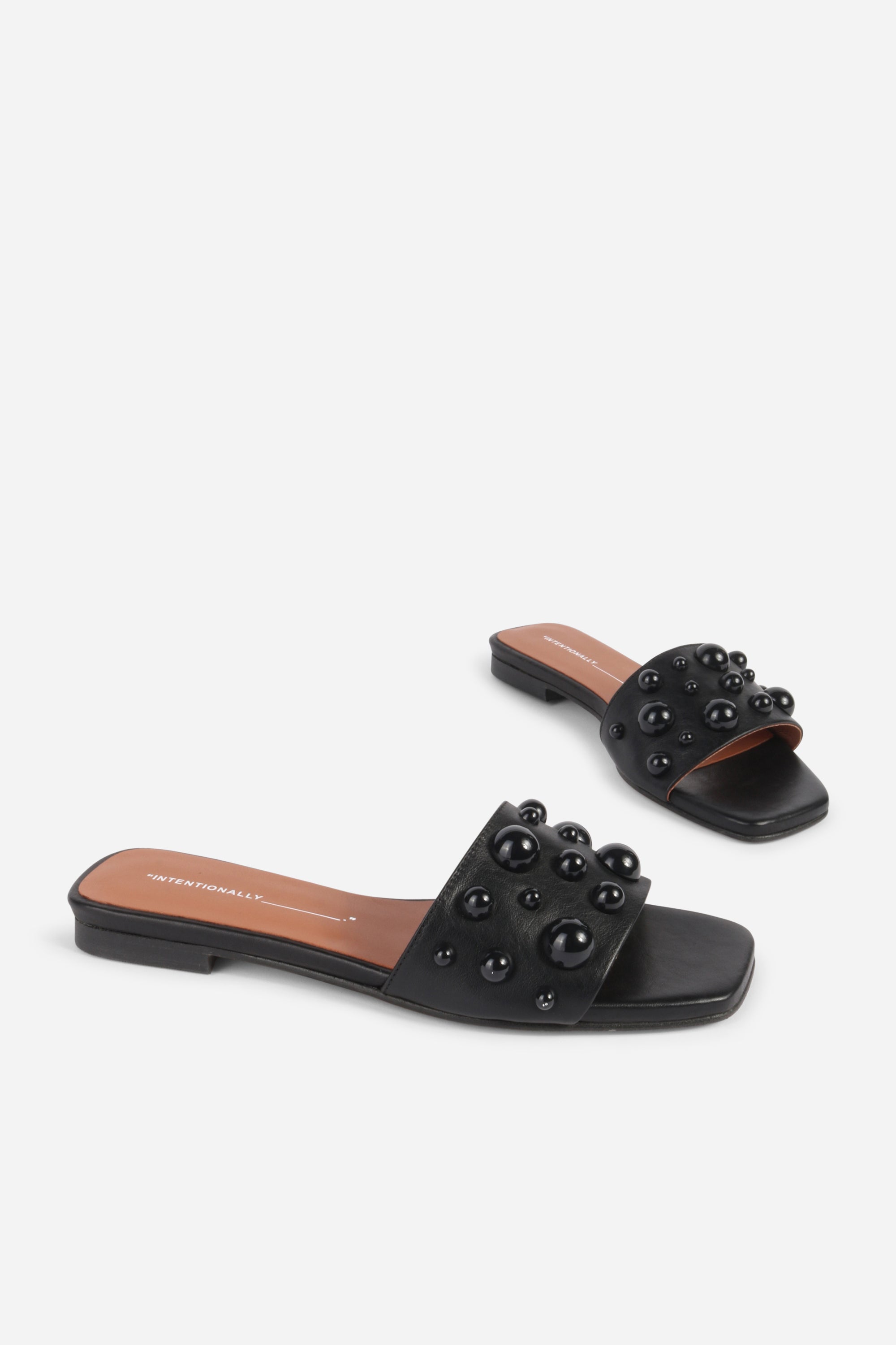 INTENTIONALLY __________. Cocktail Leather Slide