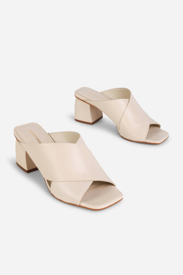 INTENTIONALLY __________. Lefty Mule Heel Sandals