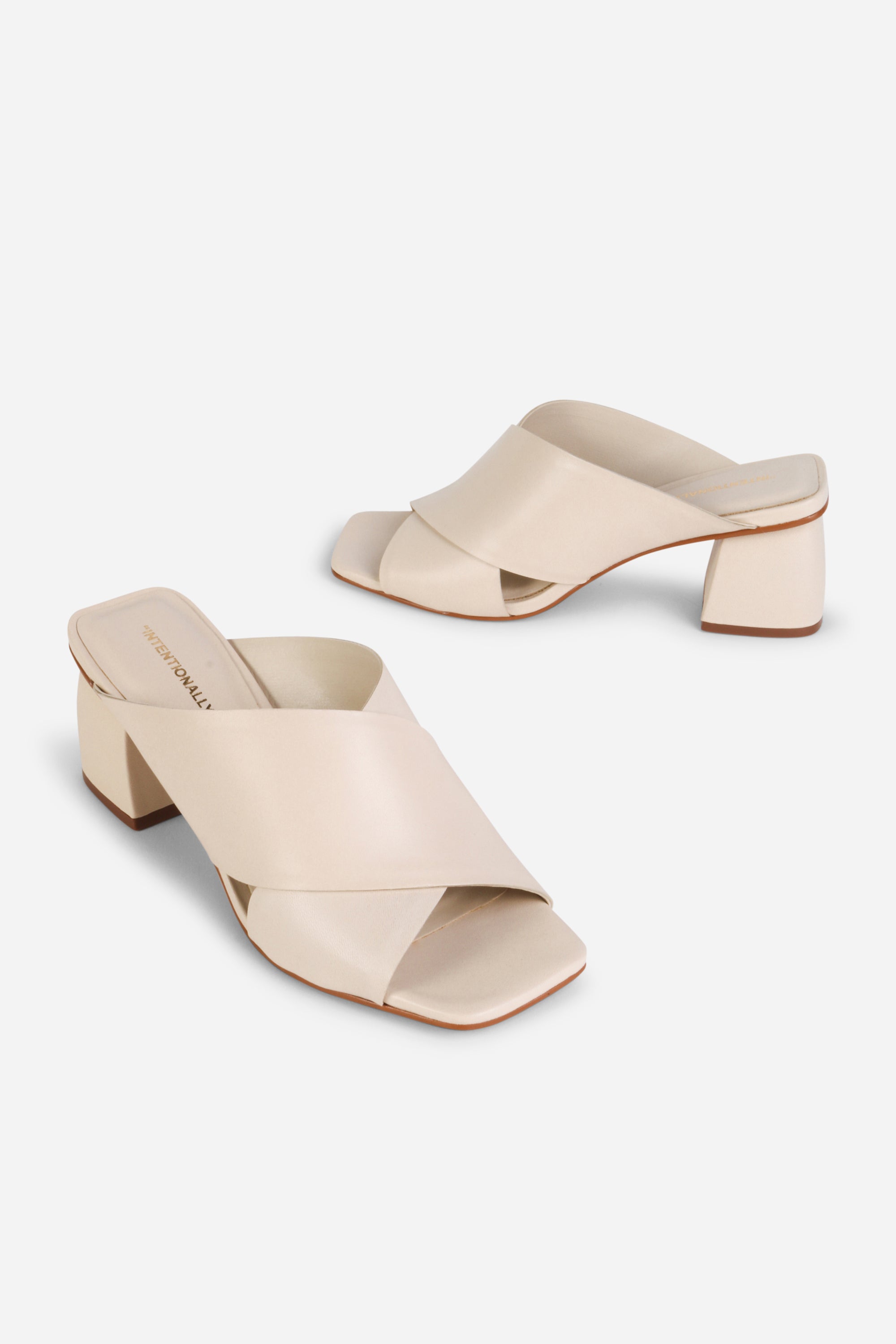 INTENTIONALLY __________. Lefty Mule Heel Sandals