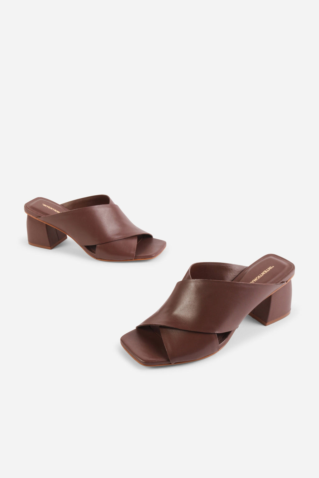 INTENTIONALLY __________. Lefty Mule Heel Sandals