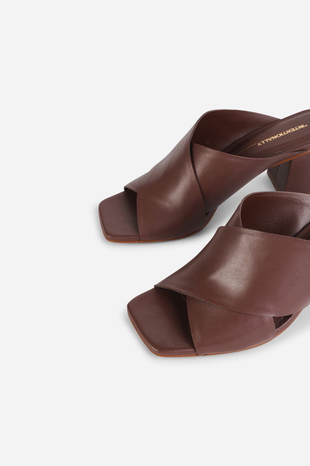 INTENTIONALLY __________. Lefty Mule Heel Sandals