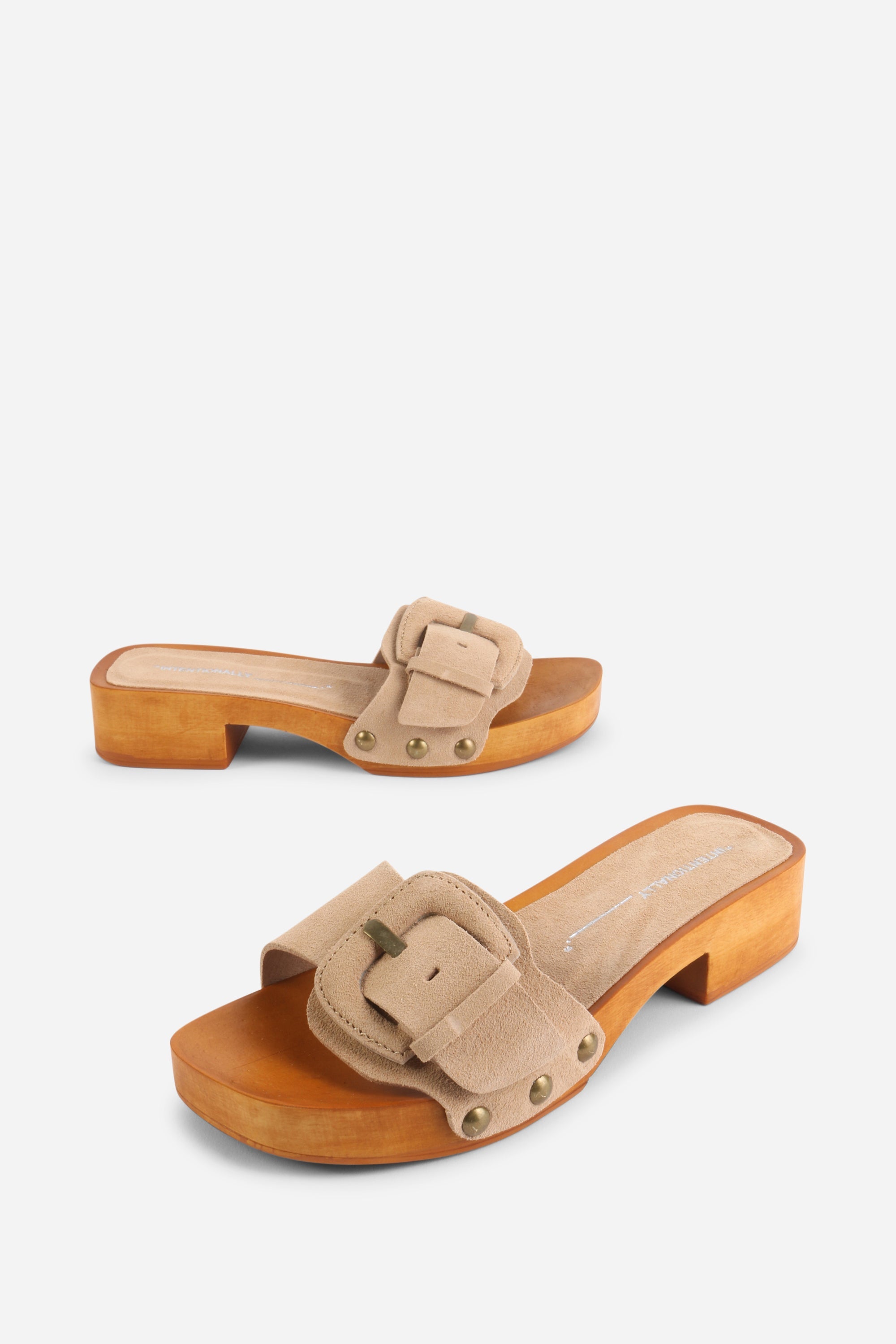 INTENTIONALLY __________. Mar Suede Clog