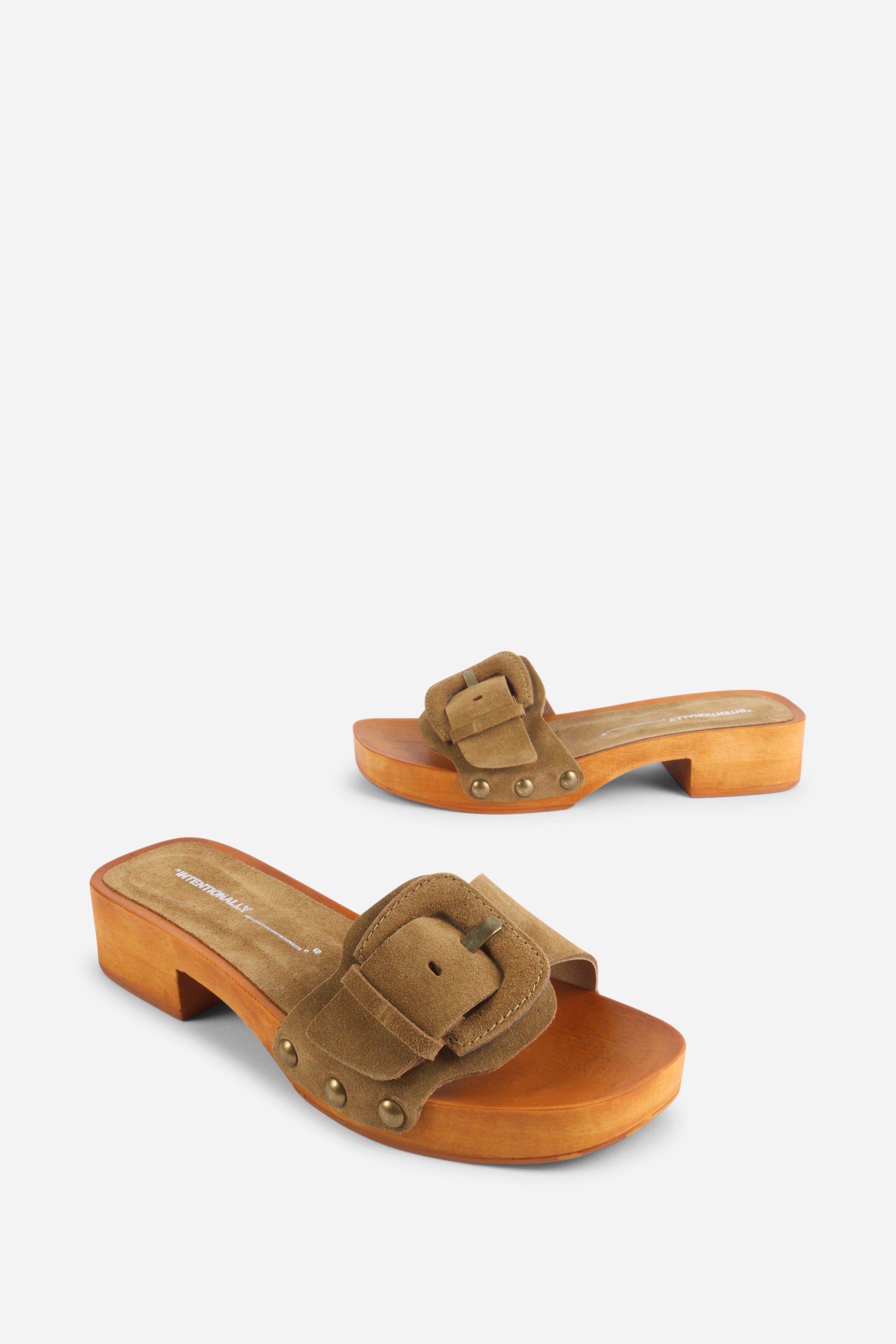 INTENTIONALLY __________. Mar Suede Clog
