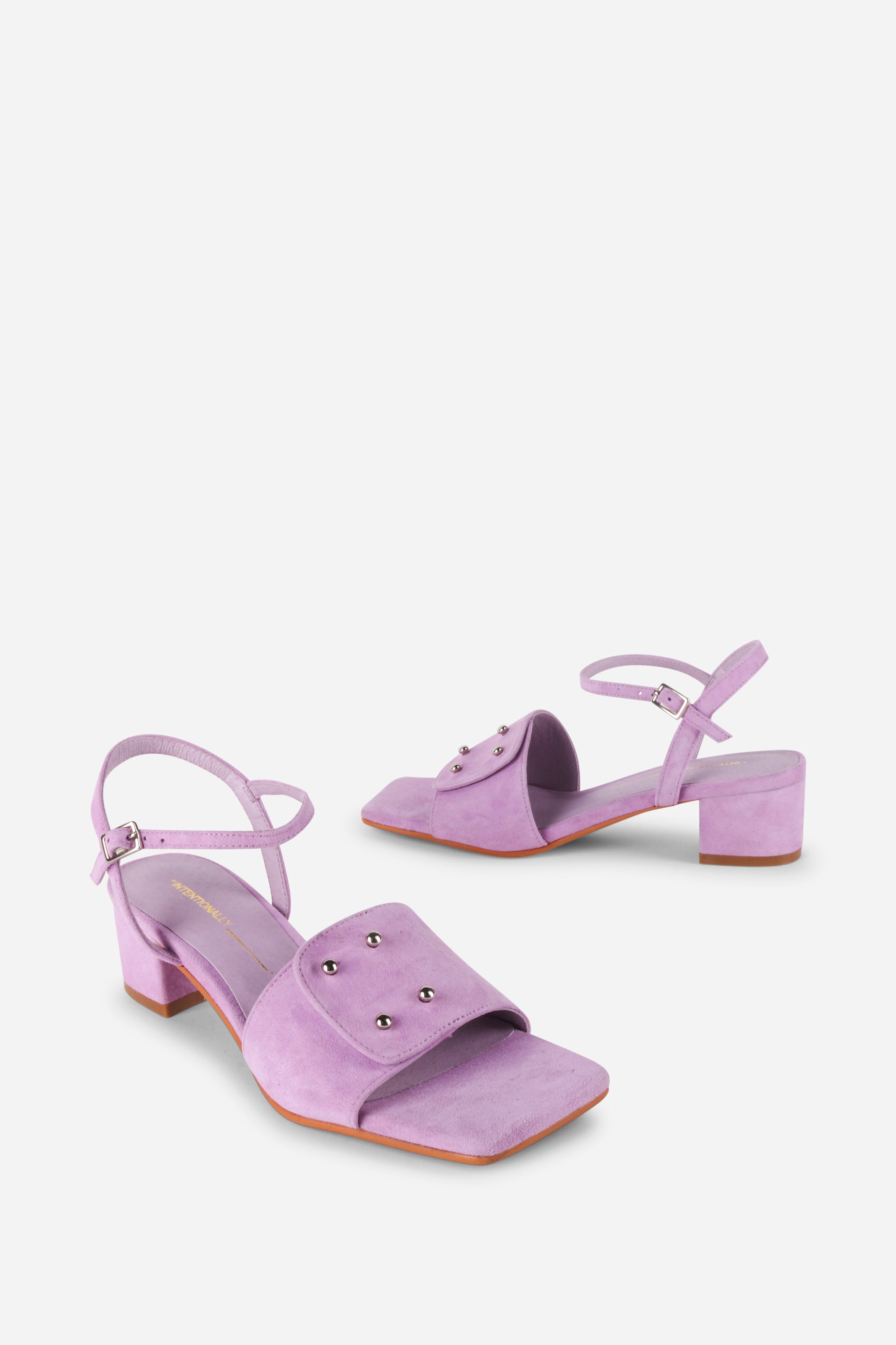 INTENTIONALLY __________. Karizma Block Heel Sandal