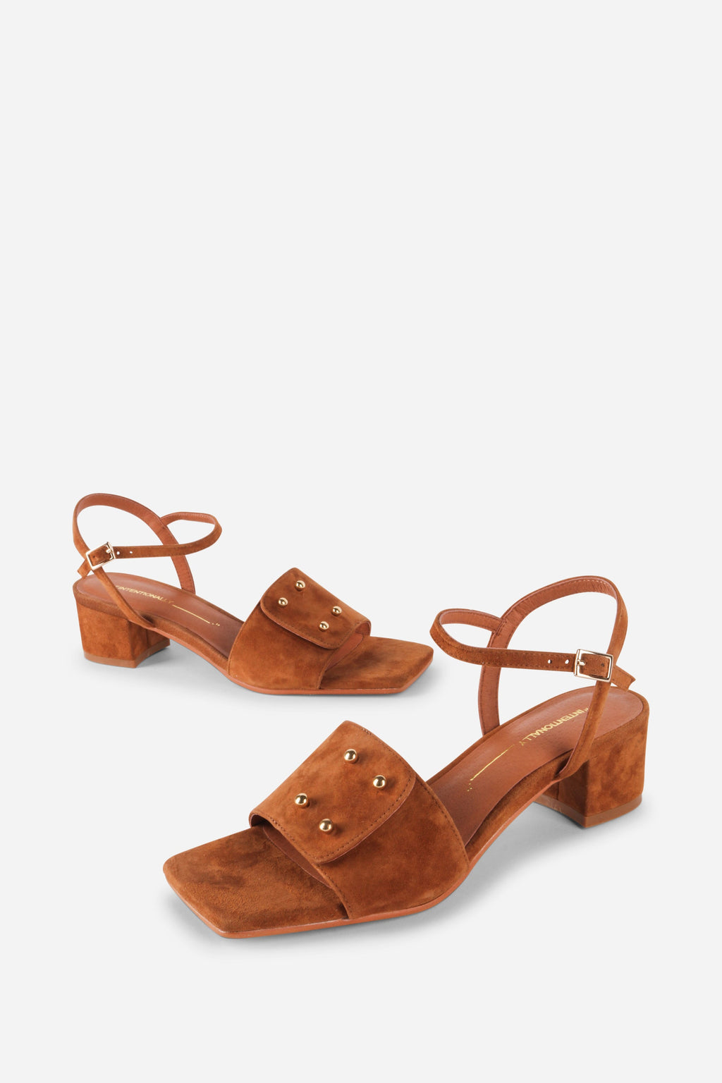 INTENTIONALLY __________. Karizma Block Heel Sandal