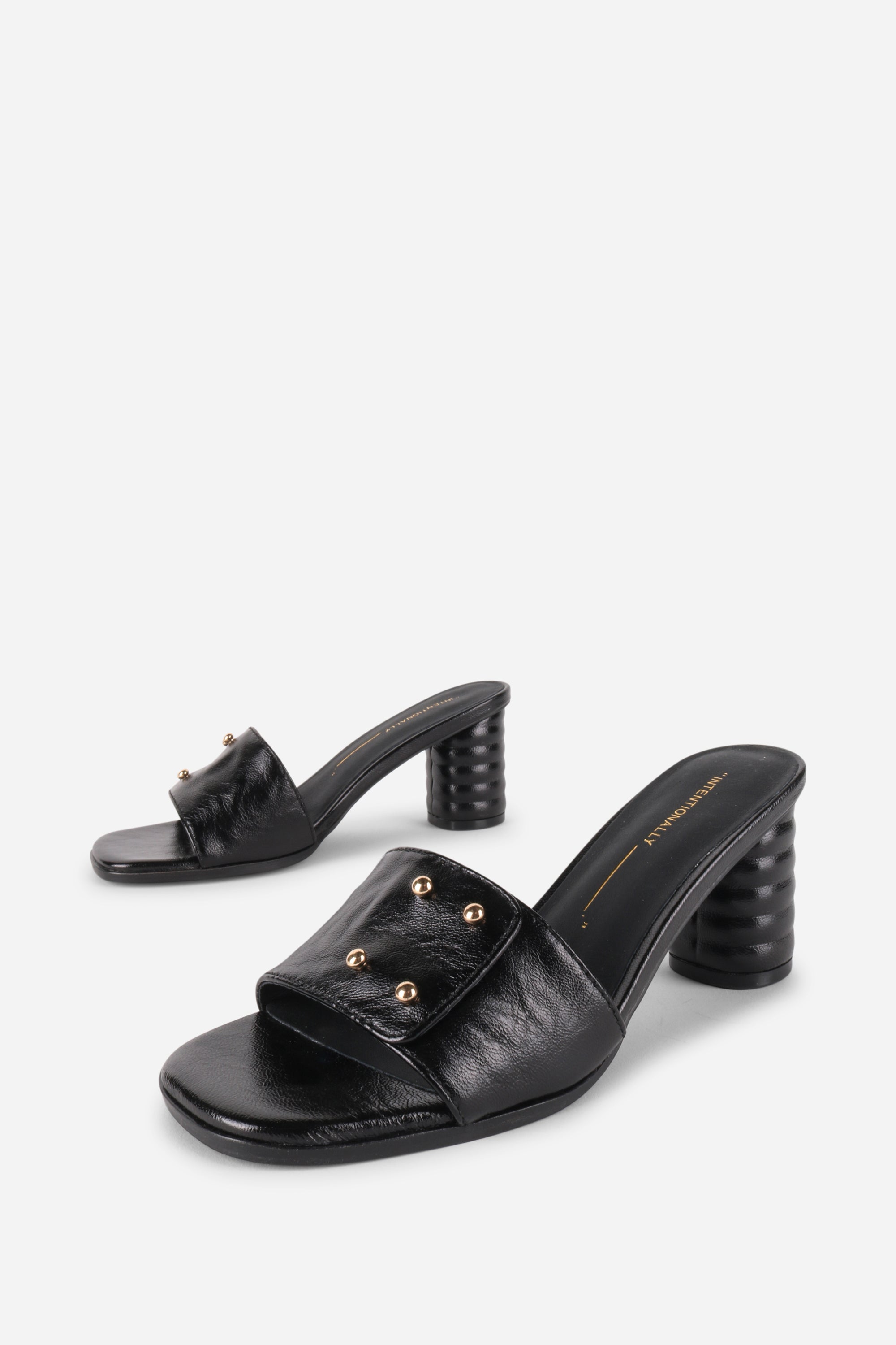 INTENTIONALLY __________. Kizmit Mule Heels