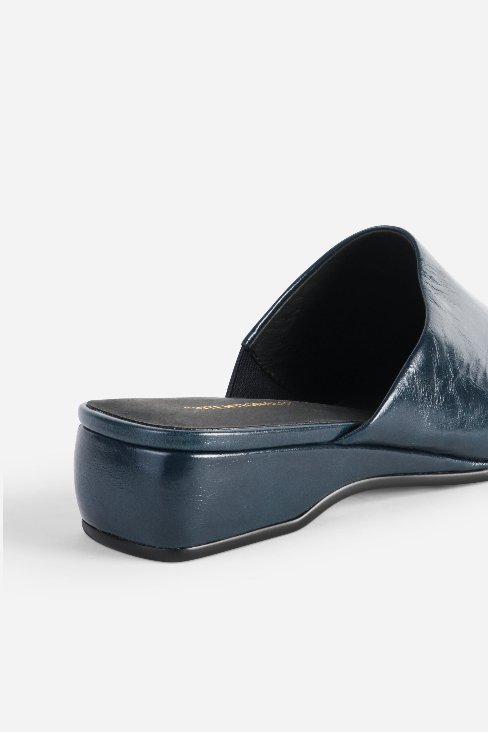 INTENTIONALLY __________. Marer Micro Wedge Heel Mule