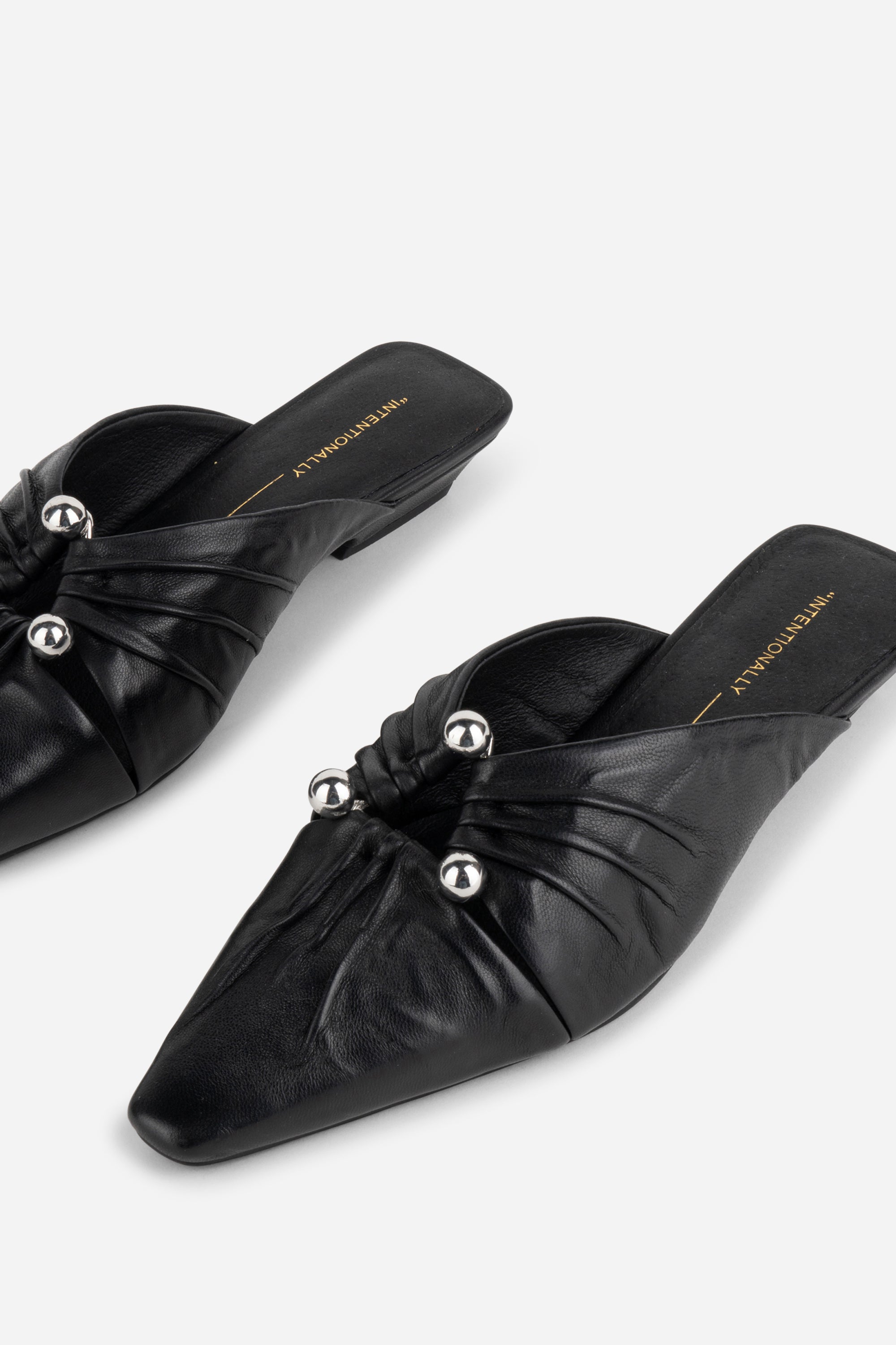 "INTENTIONALLY __________." Noah Pierced Mule