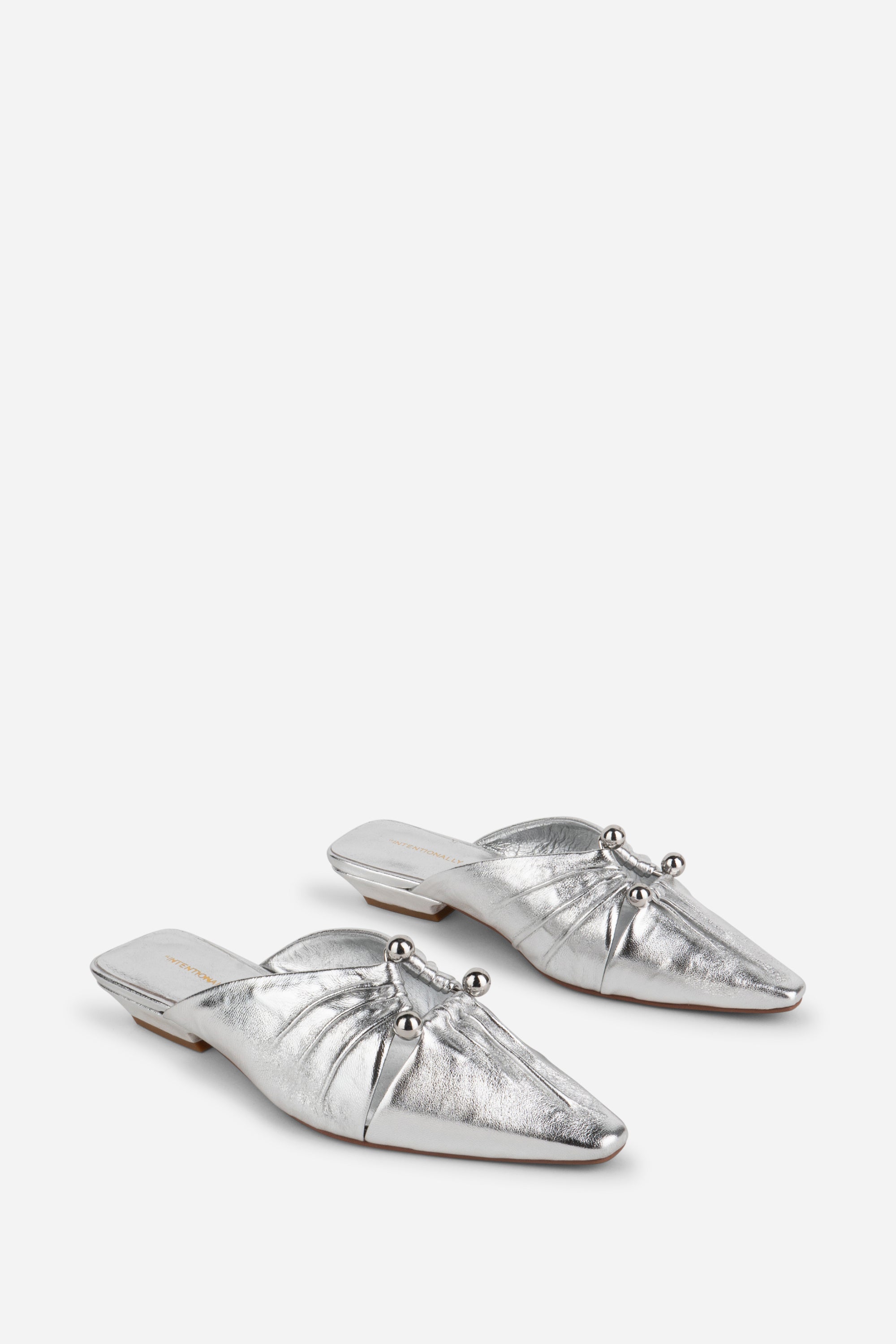 "INTENTIONALLY __________." Noah Pierced Mule