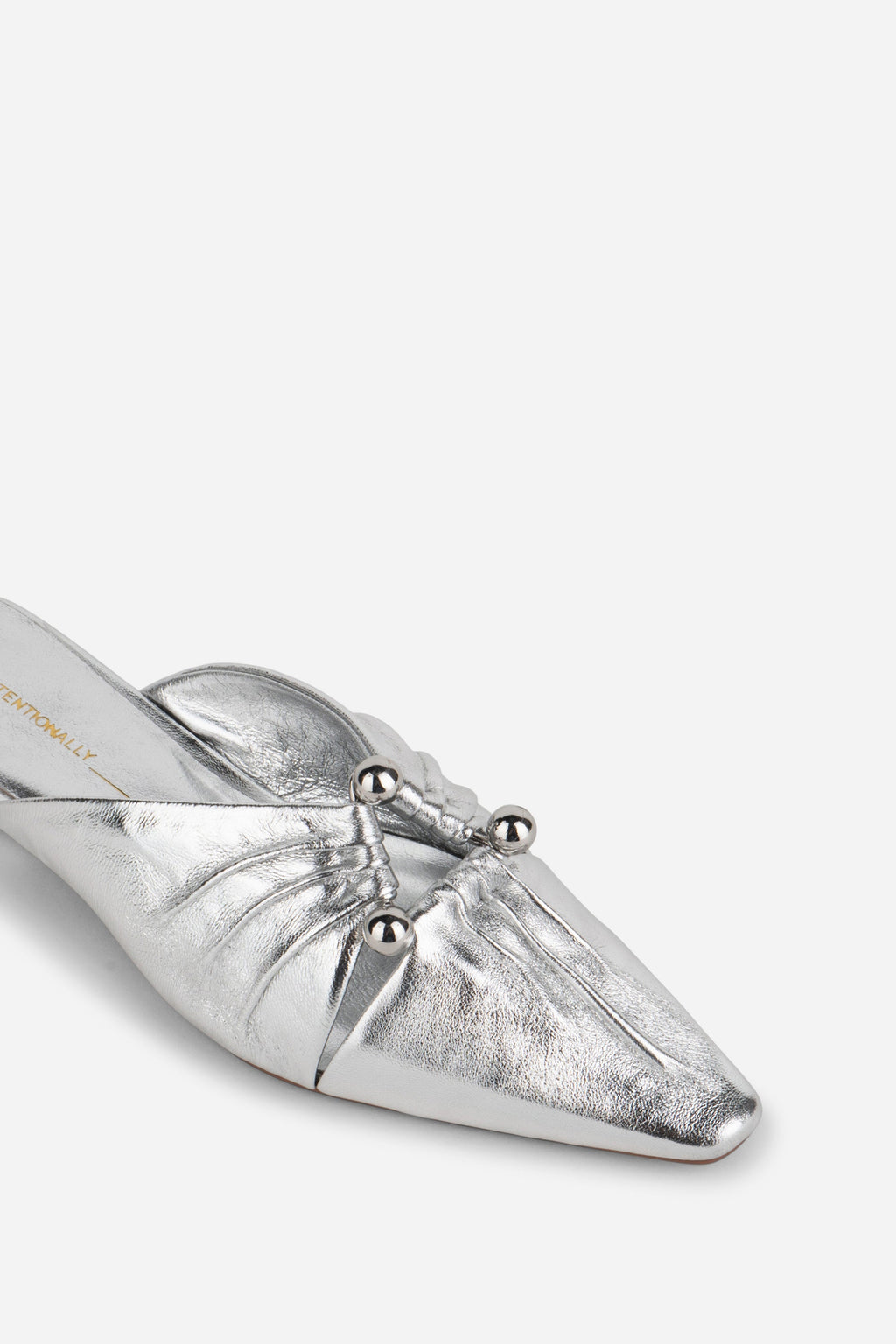 "INTENTIONALLY __________." Noah Pierced Mule