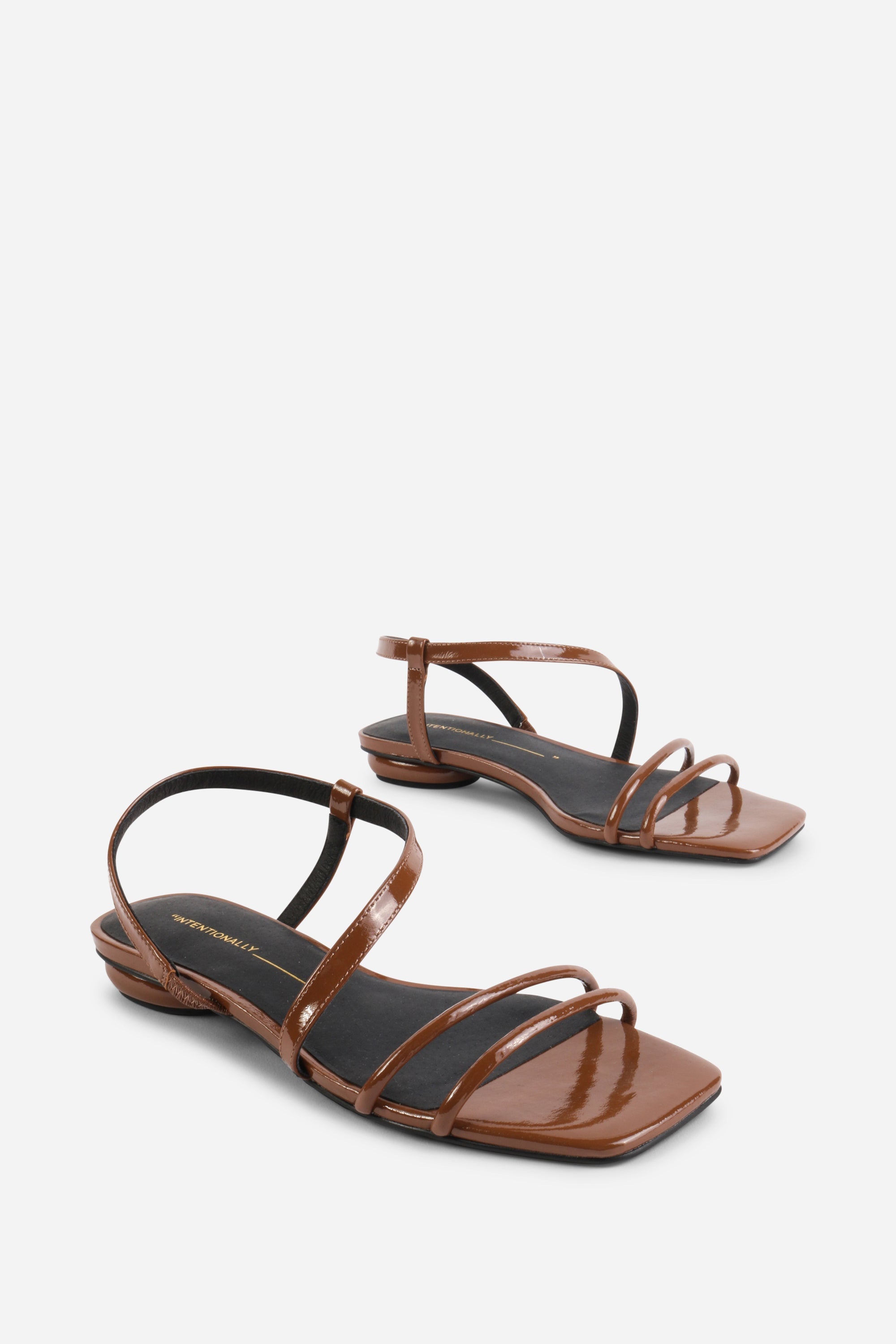 INTENTIONALLY __________. Nonfiction Flat Sandal
