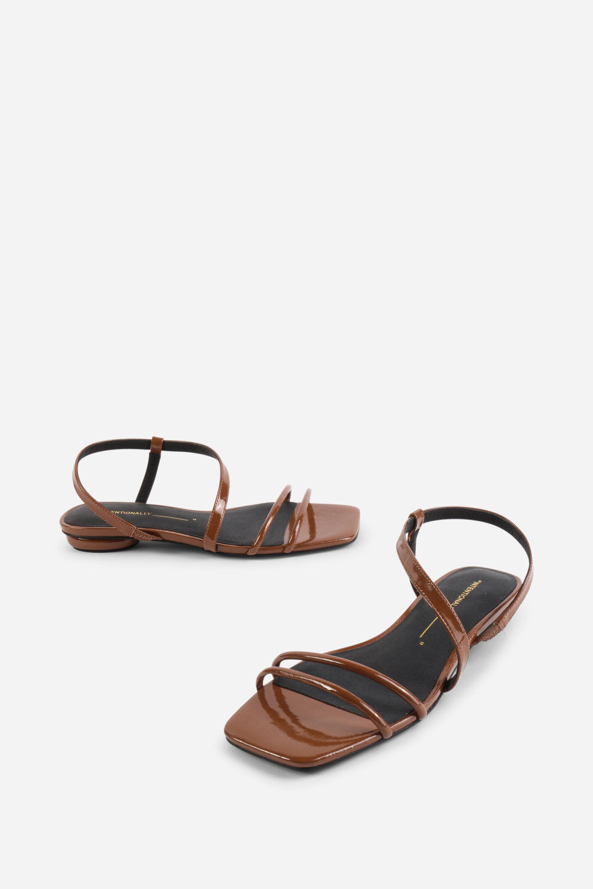 INTENTIONALLY __________. Nonfiction Flat Sandal