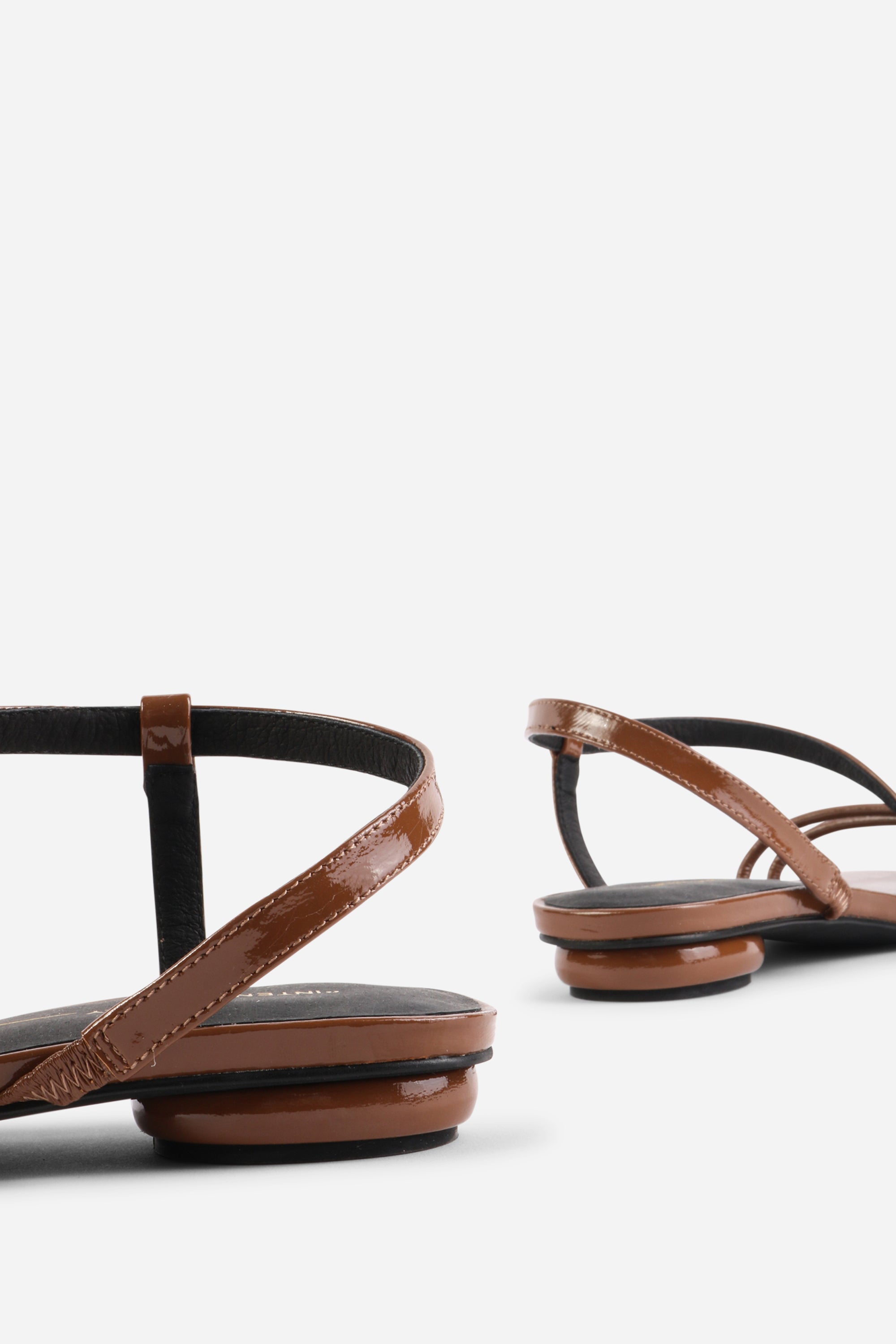 INTENTIONALLY __________. Nonfiction Flat Sandal