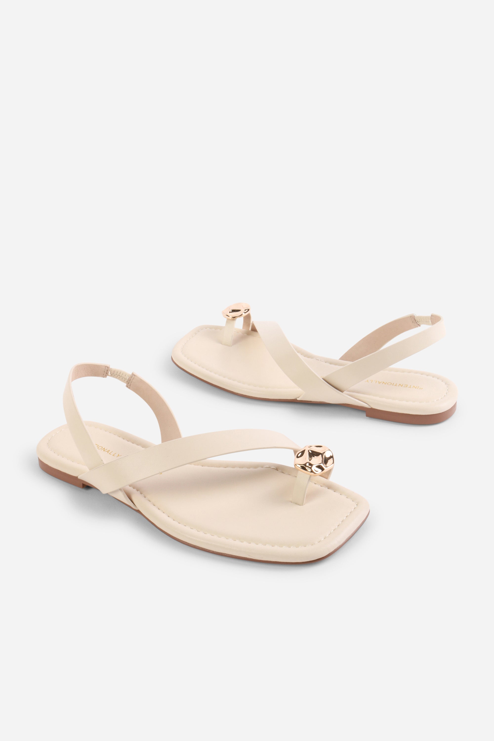 INTENTIONALLY __________. Roro Toe Ring Slingback Flat Sandal