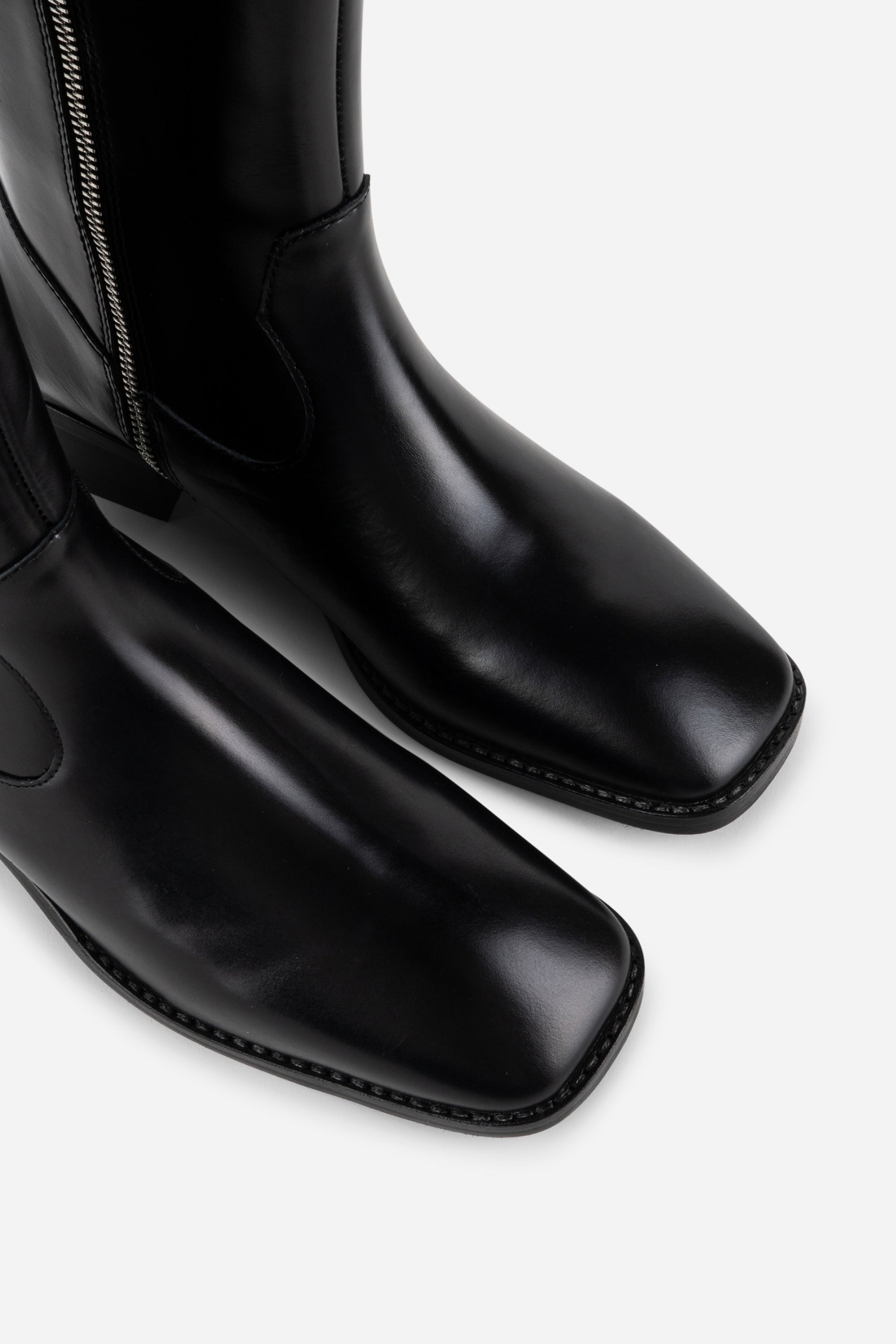 INTENTIONALLY __________. Tame Knee High Boot - Black