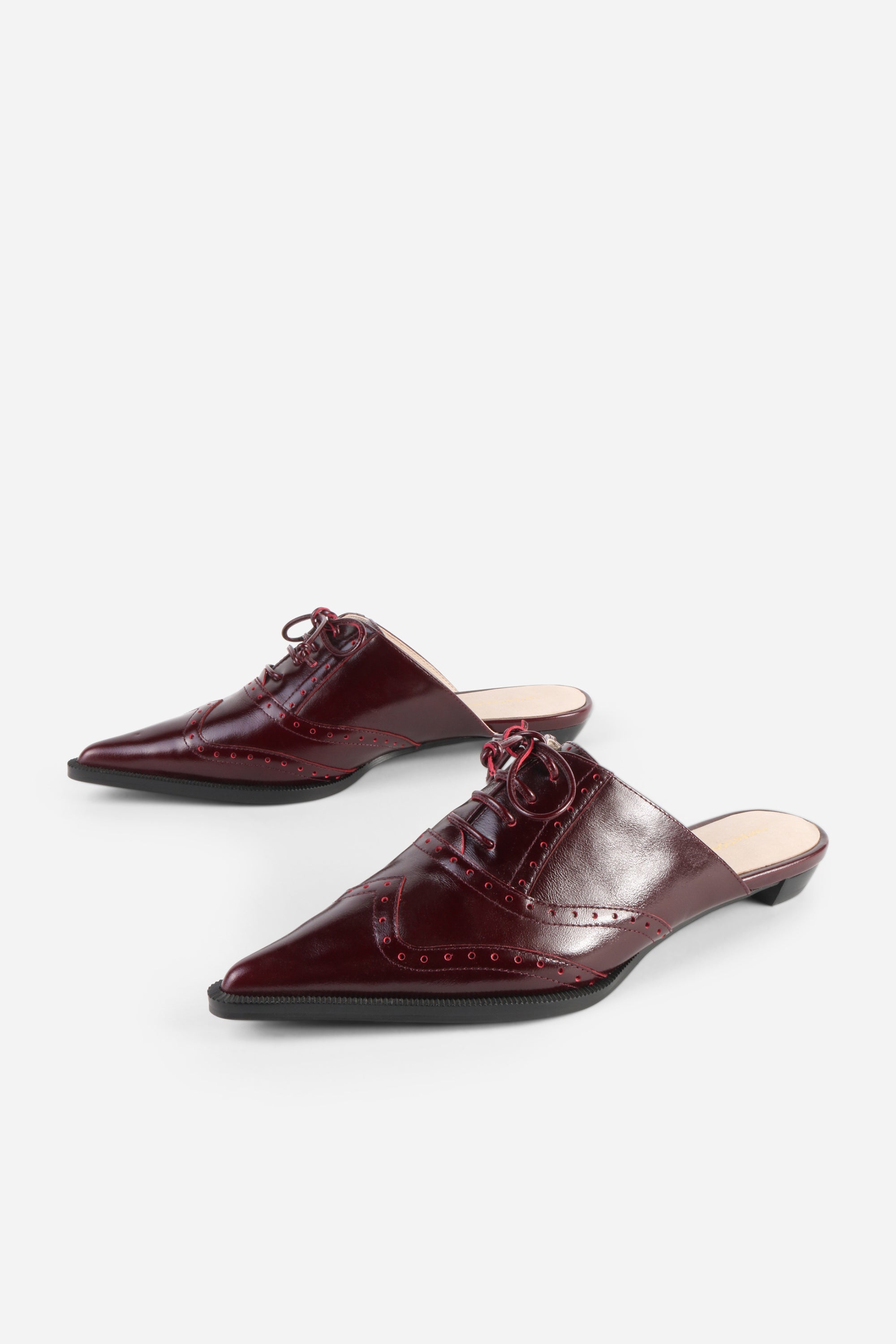 INTENTIONALLY __________. Tonian Lace-Up Flat Mule