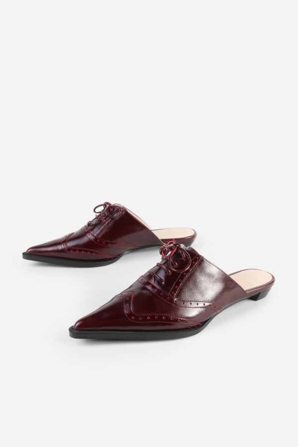 INTENTIONALLY __________. Tonian Lace-Up Flat Mule