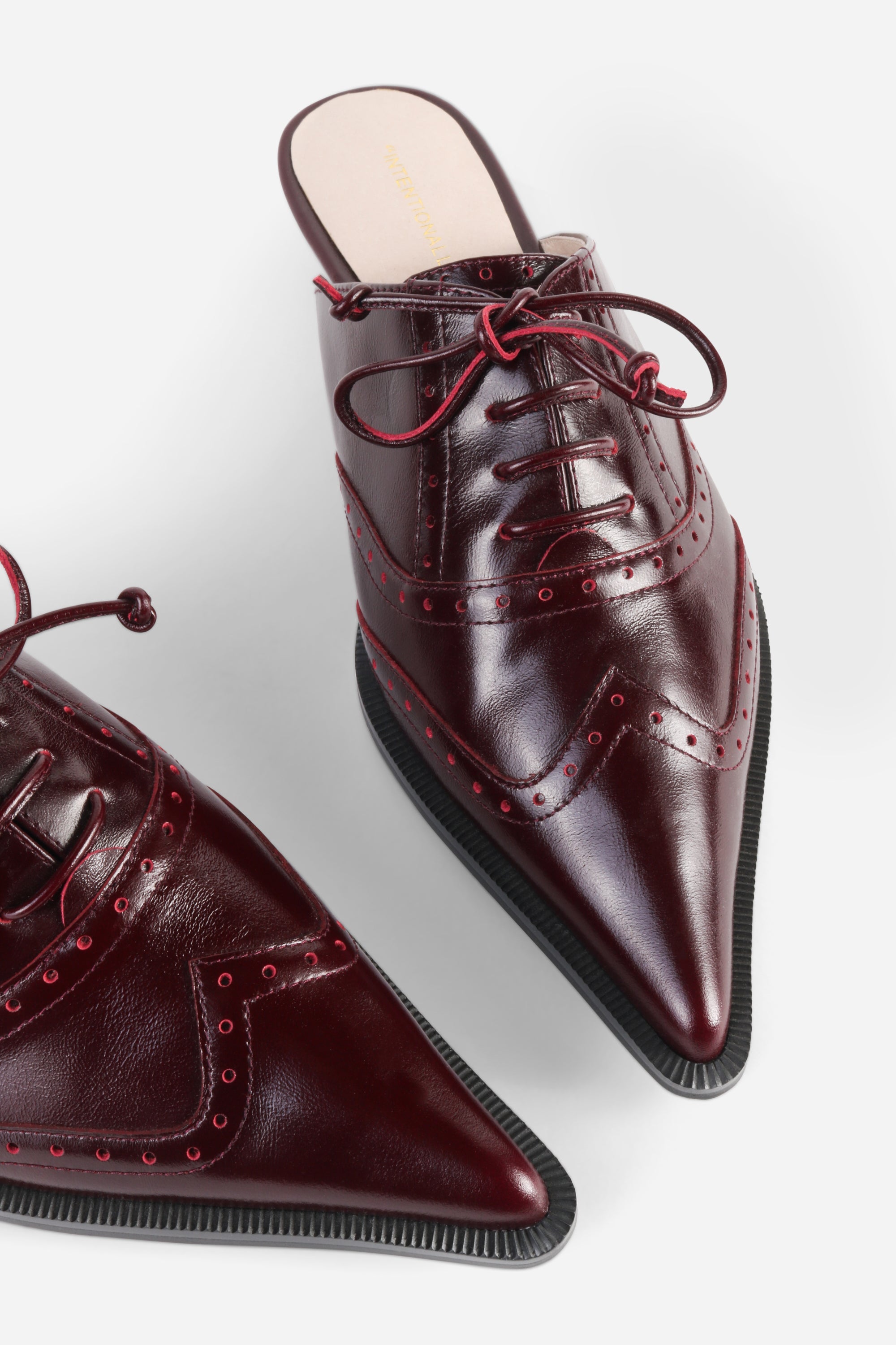 INTENTIONALLY __________. Tonian Lace-Up Flat Mule