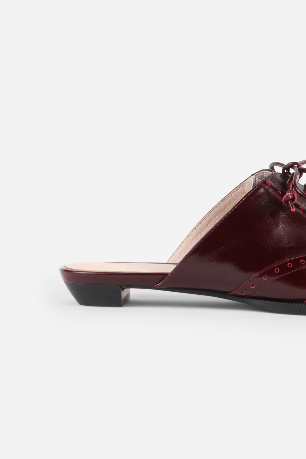 INTENTIONALLY __________. Tonian Lace-Up Flat Mule
