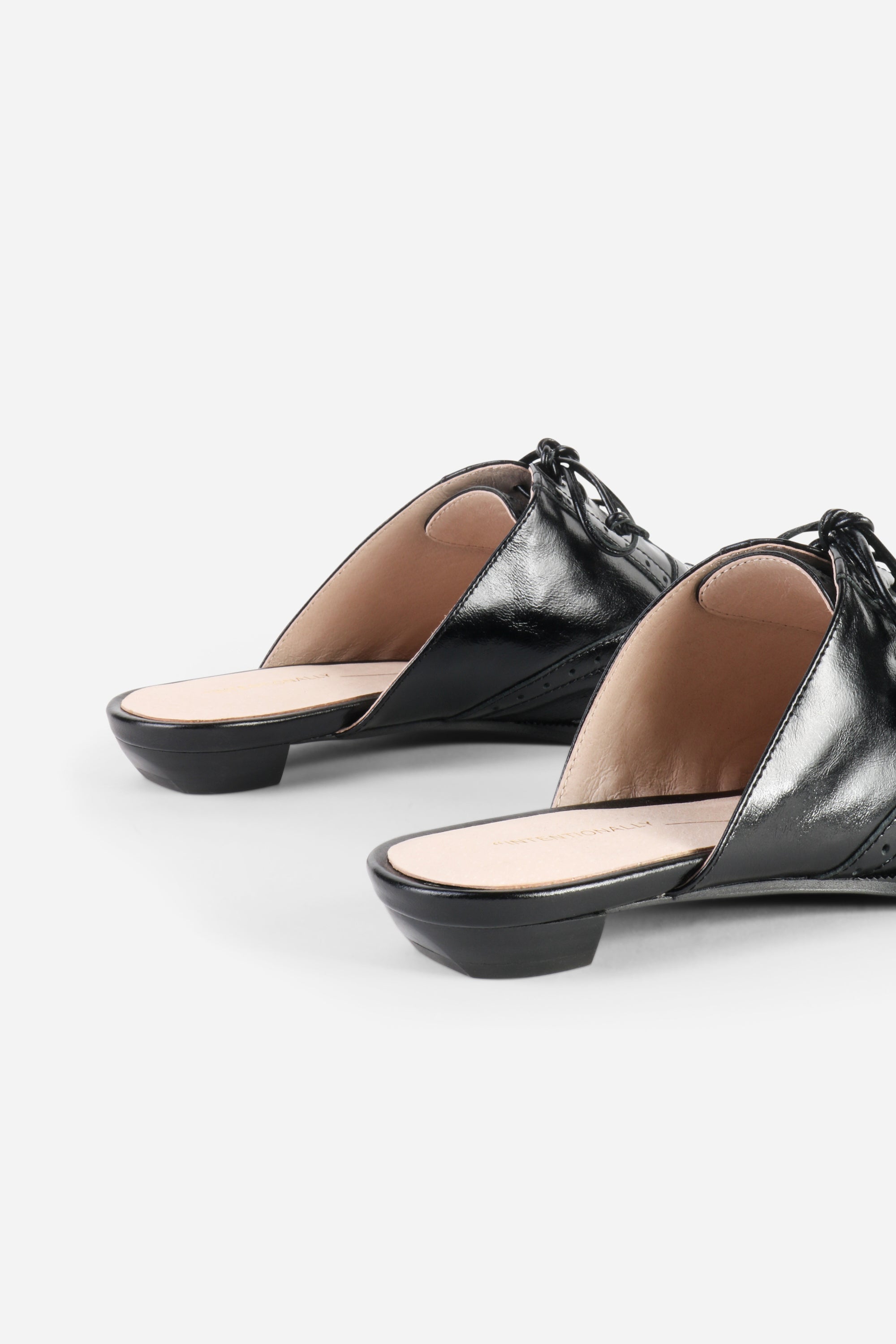 INTENTIONALLY __________. Tonian Lace-Up Flat Mule