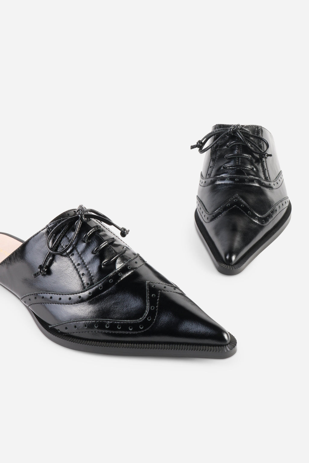 INTENTIONALLY __________. Tonian Lace-Up Flat Mule
