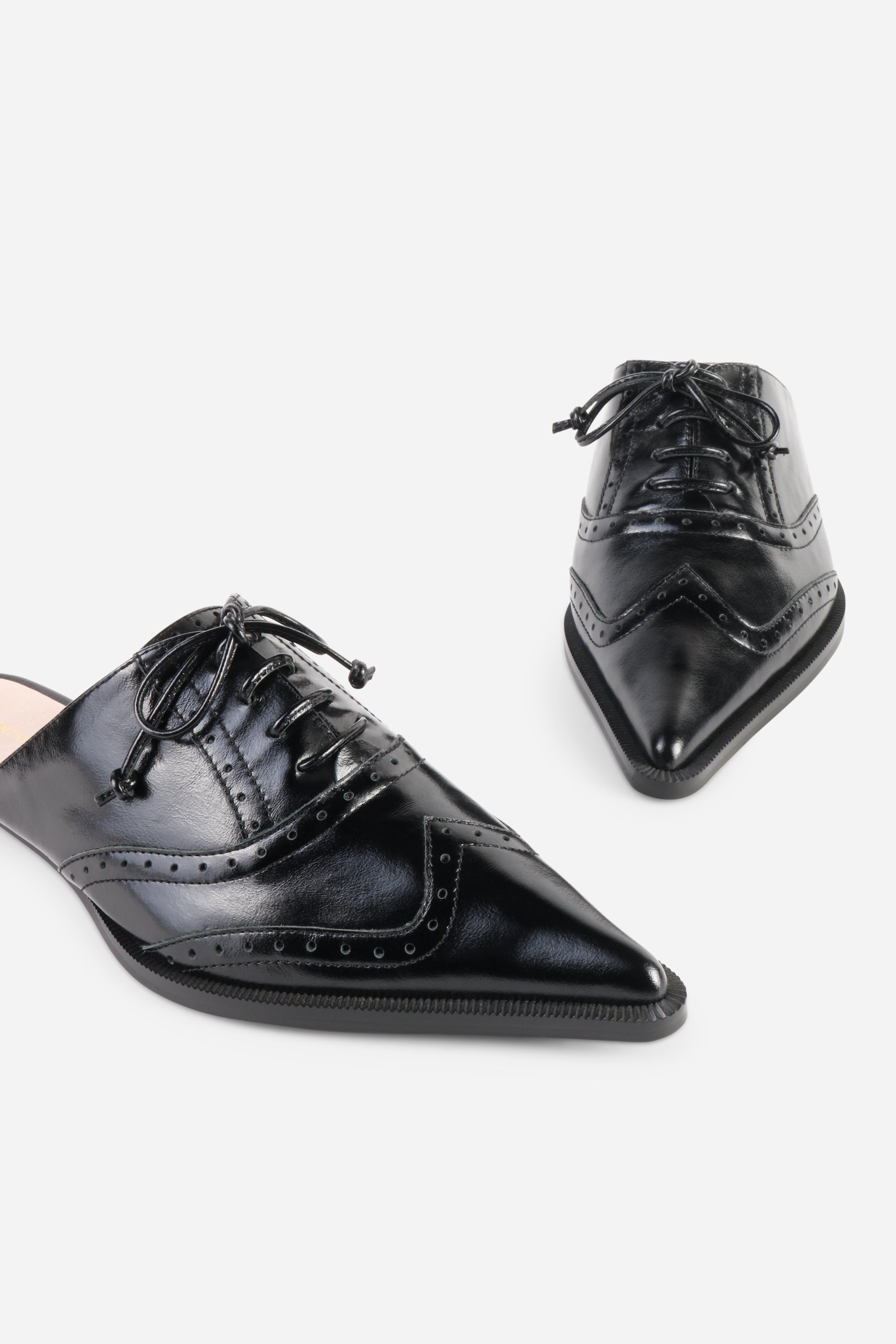 INTENTIONALLY __________. Tonian Lace-Up Flat Mule